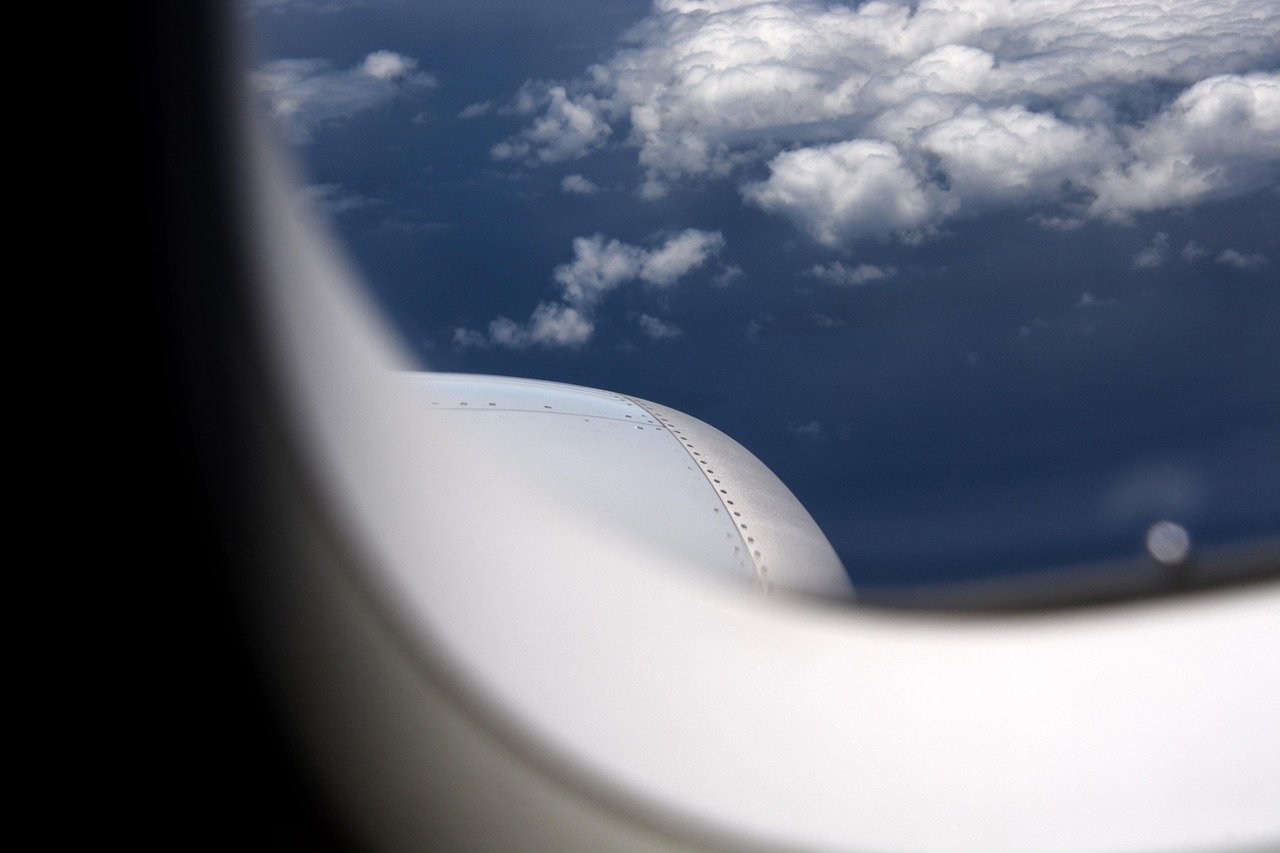 Airplane Seat Swaps: How to Say No Without Being Rude 1 Airplane window view clouds