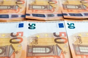 Budget travel blueprint coins and world map