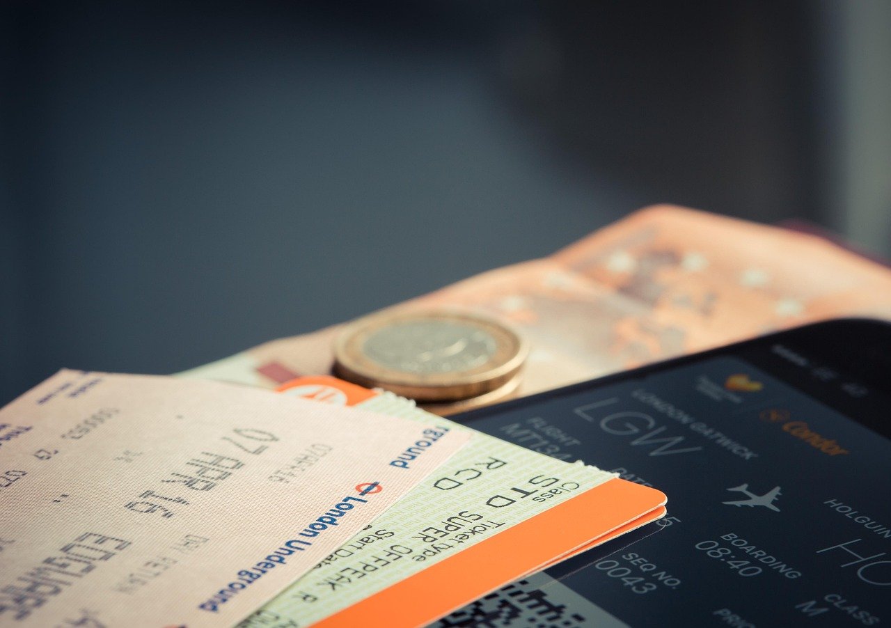 Smartphone next to boarding passes and travel documents on a table