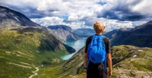 Traveler overlooking scenic mountain viewpoint while seeking hidden travel gems